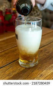 Pouring Of Light Lager Beer In Glass In Polish Bar