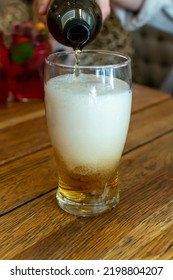 Pouring Of Light Lager Beer In Glass In Polish Bar