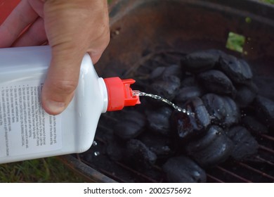 Pouring Lighter Fluid On A Barbeque Grill