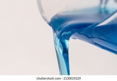 Pouring Liquid Detergent from a Cup - Shutterstock ID 2130019229