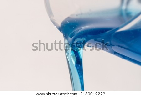 Pouring Liquid Detergent from a Cup