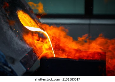 Pouring Liquid Gold Into Graphite Casting Form From Furnace