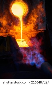 Pouring Liquid Gold Into Graphite Casting Form From Furnace