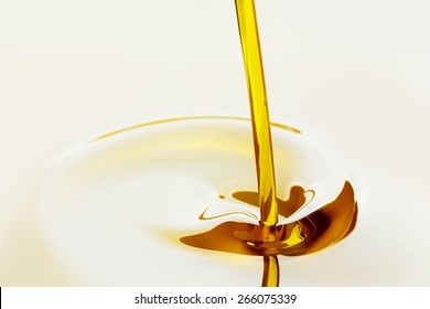 Pouring Liquid Golden Oil Close Up View