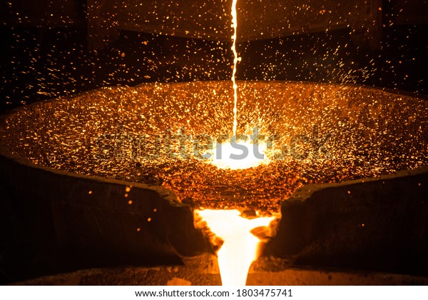 Pouring liquid metal from\
arc furnace