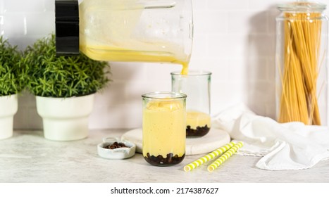 Pouring Mango Boba Smoothie Into The Drinking Glasses.