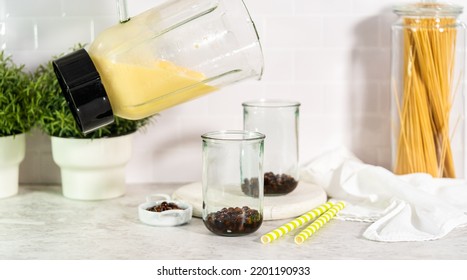 Pouring Mango Boba Smoothie Into The Drinking Glasses.