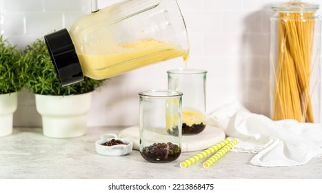 Pouring Mango Boba Smoothie Into The Drinking Glasses.