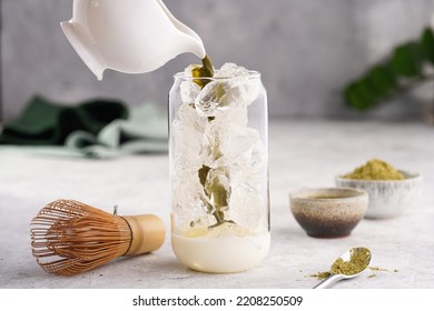 Pouring Matcha Tea Into Tall Boba Tea Glass With Ice And Milk To Make Matcha Latte