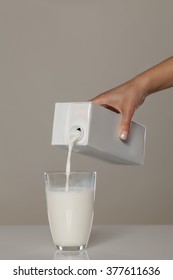 Pouring Milk From The Carton Into A Glass