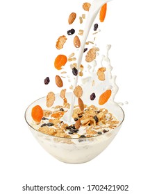 Pouring Milk And Falling Muesli Over A Transparent Bowl. Isolated On White. Healthy Breakfast 