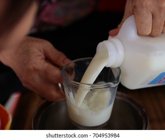 Pouring Milk With Human Hand.