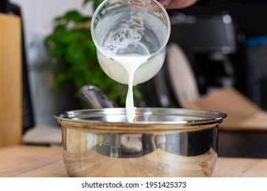 Pouring Milk Into A Pot. Preparation Of Béchamel Sauce.