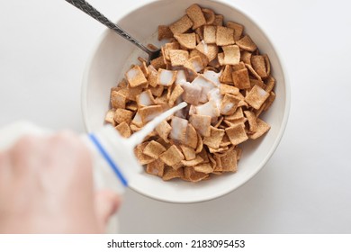 Pouring Milk Over Cinnamon Toast Crunch Cereal - Shutterstock ID 2183095453