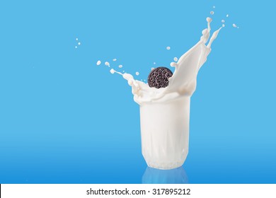 Pouring Milk Splash cookies and creme, on blue background    - Powered by Shutterstock