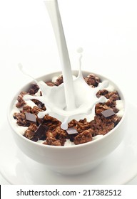 Pouring Milk With A Splash Of Droplets Into A Bowl Of Crunchy Choc Chip Breakfast Cereal Rich In Wheat, Oats And Bran For An Energising Low-CI Start To The Day