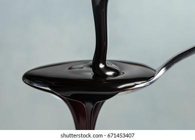 Pouring Molasses On A Spoon