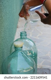 Pouring Moonshine Vodka Into A Large Decanter At Home