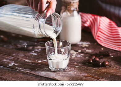 Pouring new milk into glass closeup. Fresh rustic beverage, drinking organic milk. Healthy lifestyle, natural product, vitamins for children concept - Powered by Shutterstock