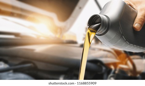 Pouring oil to car engine