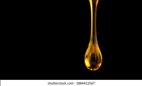 Pouring Oil Drop Isolated On Black Background. Macro Shot.