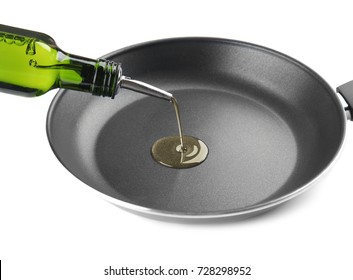 Pouring Oil Into Frying Pan On White Background