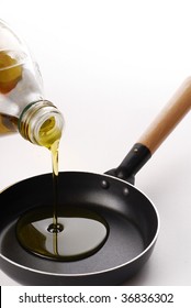 Pouring Olive Oil Over A Pan.