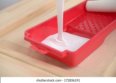 Pouring A Paint Into A Painting Tray