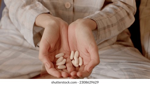 Pouring pills into the patient's hands, a handful of medicines to balance a person's life. Emulation of a large intake of pills for the treatment of the psyche.