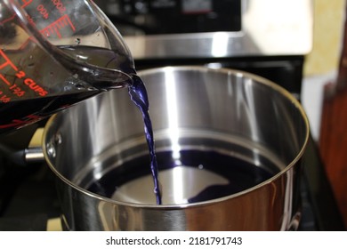 Pouring Purple Simple Syrup Into A Pot 