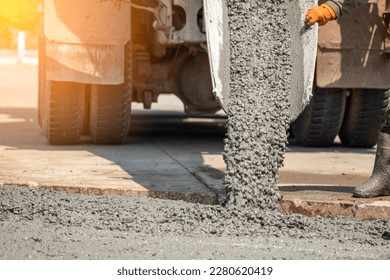 Pouring ready-mixed concrete after placing steel reinforcement to make the road by mixing in construction site	
 - Shutterstock ID 2280620419