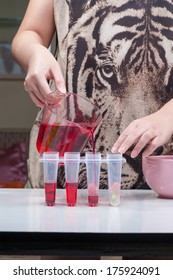 Pouring Red Sweet Drink Into Ice Pop Mold