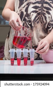 Pouring Red Sweet Drink Into Ice Pop Mold