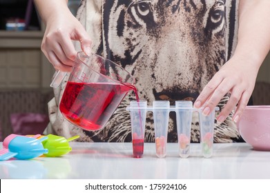 Pouring Red Sweet Drink Into Ice Pop Mold