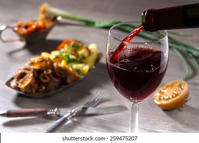 Pouring Red Wine And Food Background