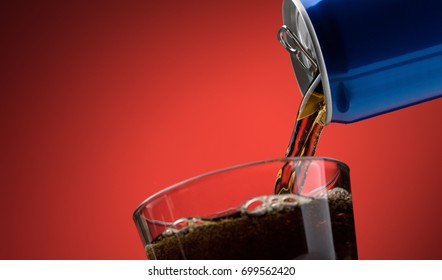 Pouring A Refreshing Sugary Soft Drink From A Can Into A Glass