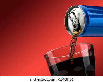 Pouring A Refreshing Sugary Soft Drink From A Can Into A Glass