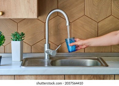 Pouring Running Purified Filtered Tap Water In Glass At Kitchen For Healthy Drinking