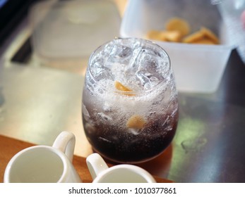 Pouring Soda Over Glass Of Ice Black Tea With Ginger Ale. Lifestyle Concept.