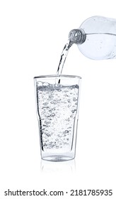 Pouring Soda Water From Bottle Into Glass On White Background