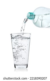 Pouring Soda Water From Bottle Into Glass On White Background