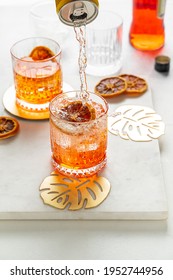 Pouring Soda Water From A Can To Make Italian Aperol Spritz Cocktail. Portrait Orientation