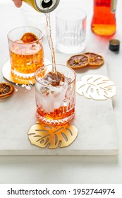 Pouring Soda Water From A Can To Make Italian Aperol Spritz Cocktail. Portrait Orientation