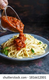 Pouring Spaghetti With Tomato Sauce. Pasta Al Pomodoro