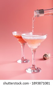 Pouring Sparkling Rose Into Coupe Glass From Wine Bottle On Pink Background, St. Valentines Day Greeting Card