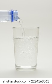 Pouring Sparkling Water Into A Glass, Carbonated Water On White Background