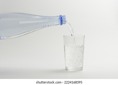 Pouring Sparkling Water Into A Glass, Carbonated Water On White Background