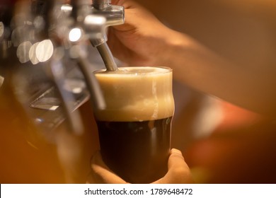 Pouring Stout Beer From A Tap