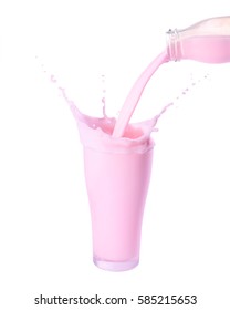 Pouring strawberry milk from bottle into glass with splashing., Isolated white background.