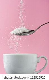 Pouring Sugar In Coffee Cup